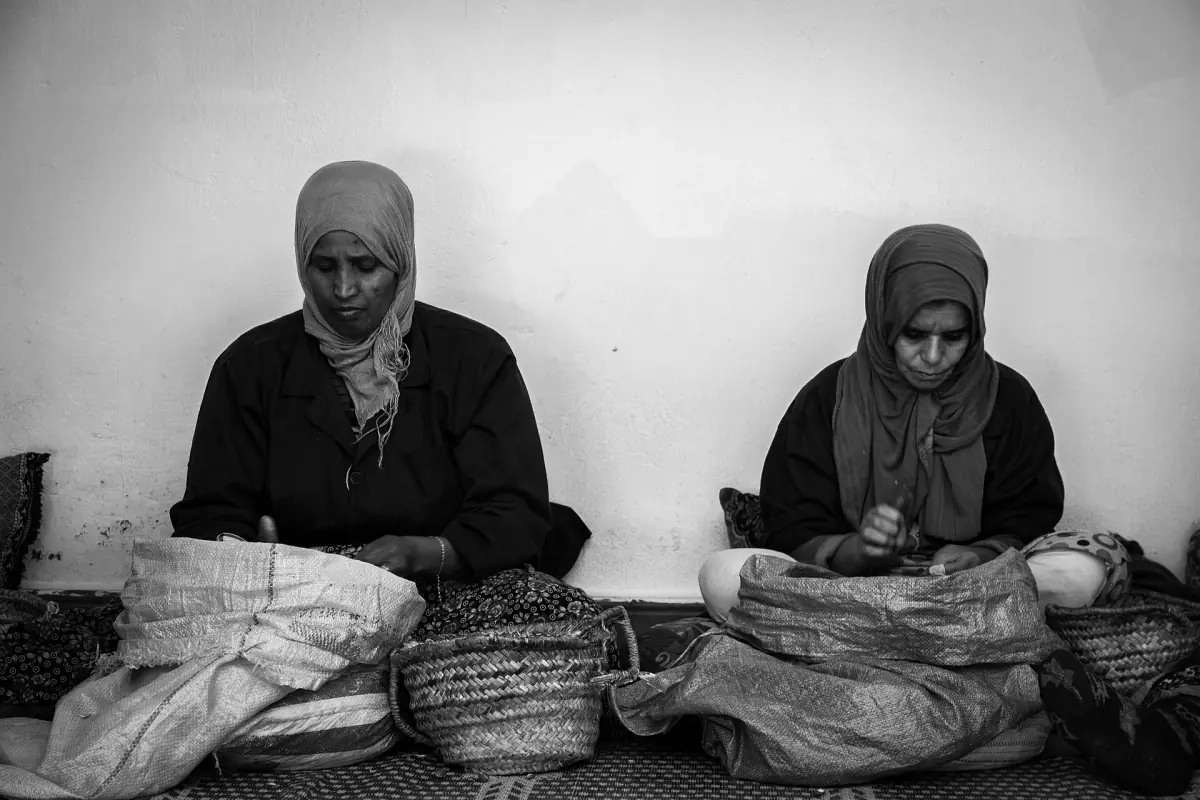 Women cracking argan nuts in a cooperative